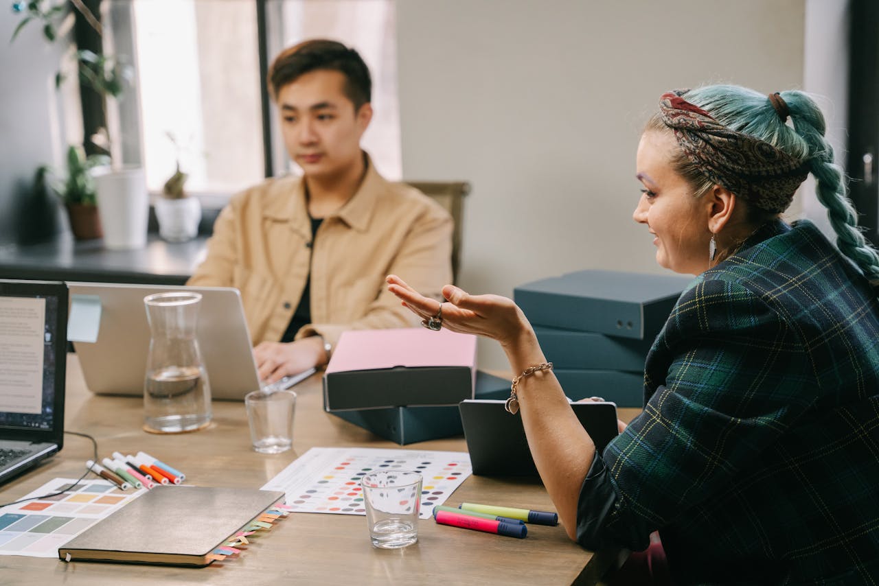 Mastering the First Impression: Your intriguing post title goes here Two coworkers engaged in a productive strategy meeting at a modern office desk.
